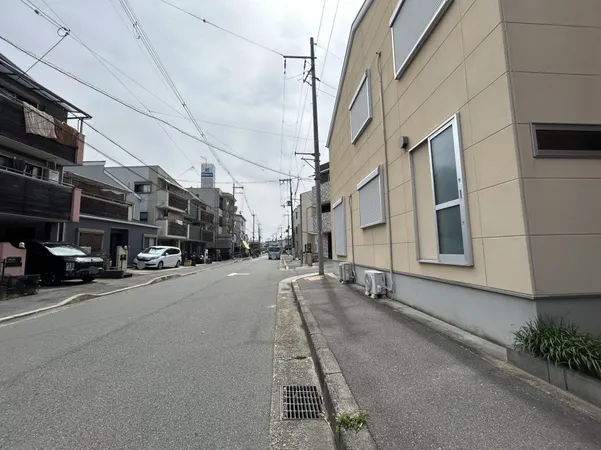 幅員のある前面道路は車の出入りがしやすく、歩道も確保されているため日常の移動や来客時にも安心感があります。道路沿いの建物は低層中心で、視界が広く開放的な雰囲気です。