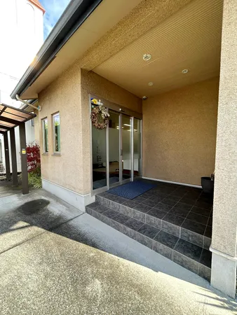 屋根付き玄関ポーチで、雨の日も快適なアプローチ。重厚感あるデザインで、建物の第一印象を高めます。