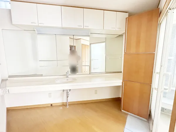 大きな鏡と収納が特徴の洗面室。明るい空間で朝の支度がしやすい印象です。